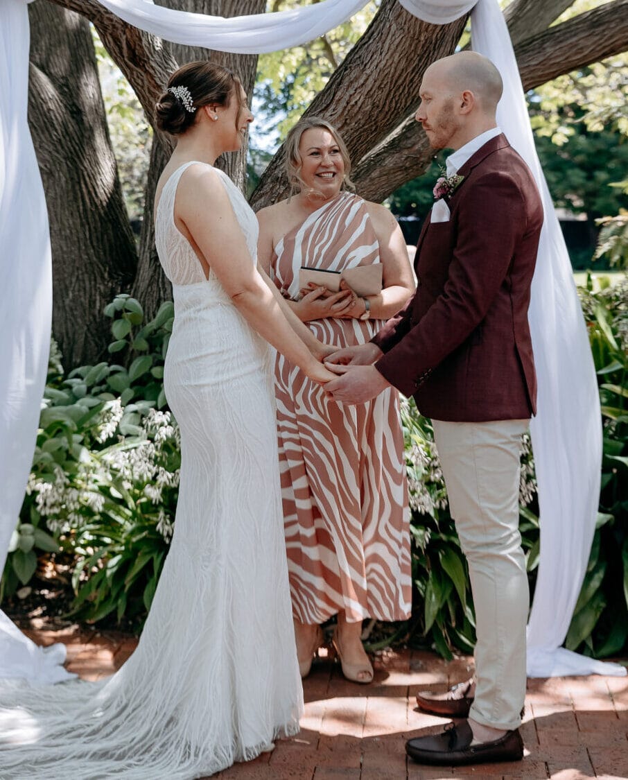 Amanda officiating a wedding ceremony under a tree